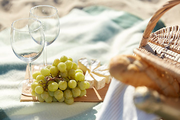 Image showing picnic with wine glasses and food on beach