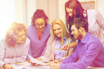 Image showing smiling team with color samples at office