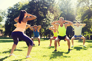 Image showing group of friends or sportsmen exercising outdoors