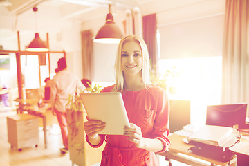 Image showing happy creative female office worker with tablet pc