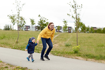 Image showing happy father and little son walking outdoors