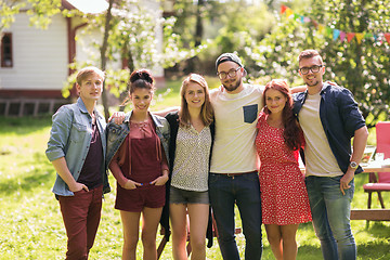 Image showing happy teenage friends hugging at summer garden