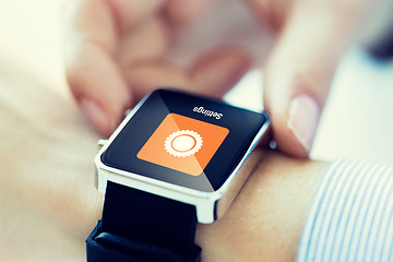 Image showing close up of hands setting smartwatch