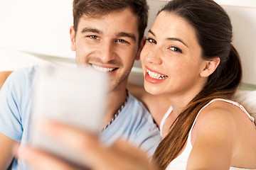 Image showing Couple on bed making selfies