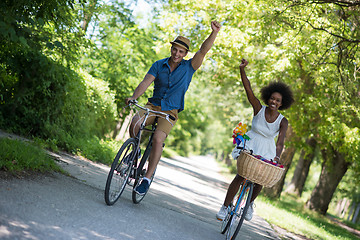 Image showing Young multiethnic couple having a bike ride in nature