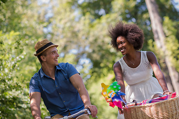 Image showing Young multiethnic couple having a bike ride in nature