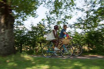 Image showing Young multiethnic couple having a bike ride in nature