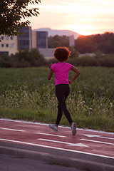 Image showing a young African American woman jogging outdoors