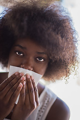 Image showing a young African American woman eating pasta