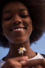 Image showing portrait of African American girl with a flower in her hand