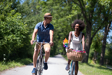 Image showing Young multiethnic couple having a bike ride in nature