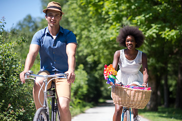 Image showing Young multiethnic couple having a bike ride in nature