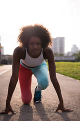 Image showing Portrait of sporty young african american woman running outdoors