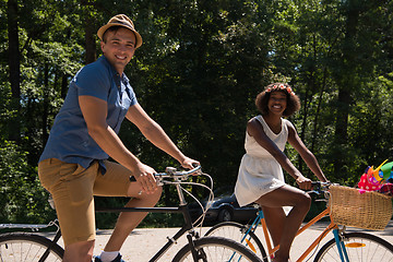 Image showing Young multiethnic couple having a bike ride in nature