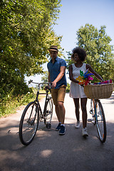 Image showing Young multiethnic couple having a bike ride in nature