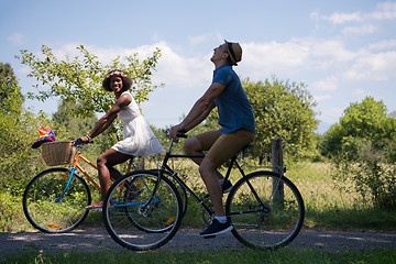 Image showing Young multiethnic couple having a bike ride in nature