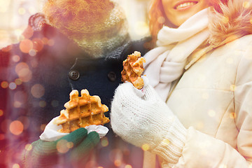 Image showing close up of happy couple eating waffles outdoors