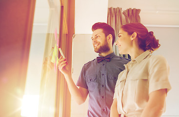 Image showing creative team with stickers on glass at office