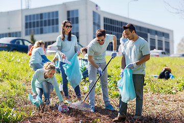 Image showing volunteers with garbage bags cleaning park area