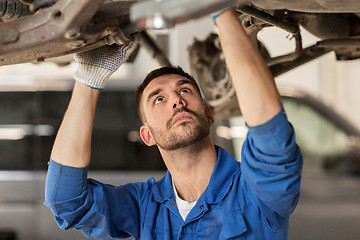 Image showing mechanic man or smith repairing car at workshop