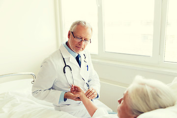 Image showing doctor checking senior woman pulse at hospital