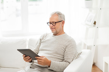 Image showing senior man with tablet pc at home