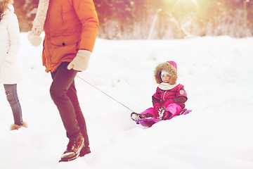 Image showing happy family with sled walking in winter forest