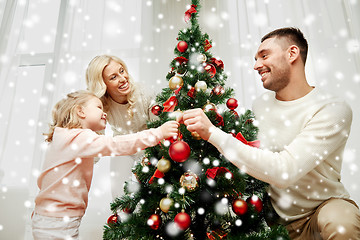 Image showing happy family decorating christmas tree at home