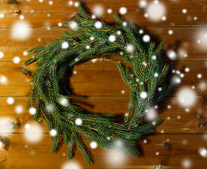 Image showing natural green fir branch wreath on wooden board