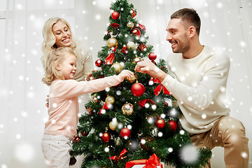 Image showing happy family decorating christmas tree at home