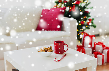 Image showing close up of christmas cookies, sugar cane and cup