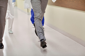 Image showing close up of medics or doctors running at hospital