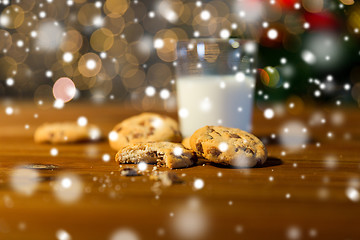 Image showing close up of cookies and milk over christmas lights