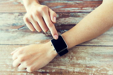 Image showing close up of hands setting smart watch