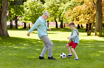 Image showing old man and boy playing football at summer park