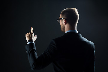 Image showing businessman pointing finger to something invisible