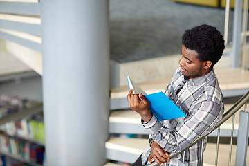 Image showing african student boy or man reading book at library