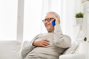 Image showing happy senior man calling on smartphone at home