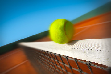 Image showing Tennis ball hitting the net