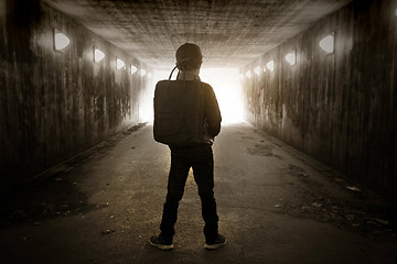 Image showing School child walking in a dark subway 