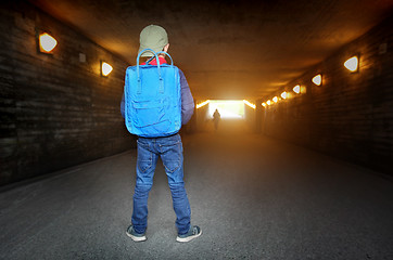 Image showing School child walking in a dark subway