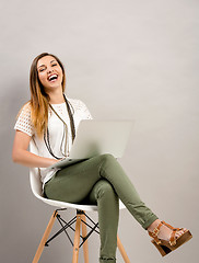 Image showing Woman working a lapptop and laughing