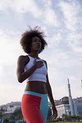 Image showing Portrait of sporty young african american woman running outdoors