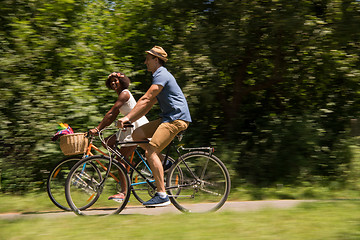 Image showing Young multiethnic couple having a bike ride in nature