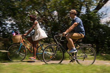 Image showing Young multiethnic couple having a bike ride in nature