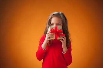 Image showing The cute cheerful little girl on orange background