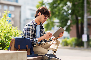 Image showing man with tablet pc sitting on city street bench