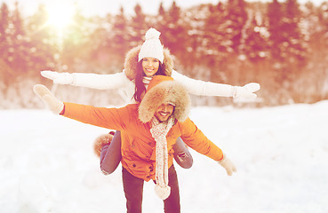 Image showing happy couple having fun over winter background