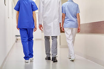 Image showing group of medics or doctors walking along hospital