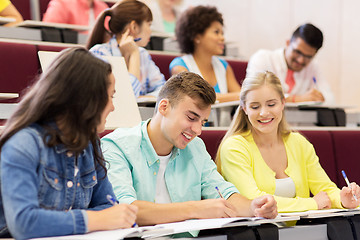 Image showing group of students with notebooks in lecture hall